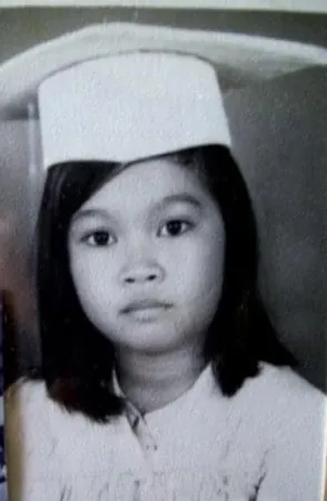 Merce in a white graduation cap