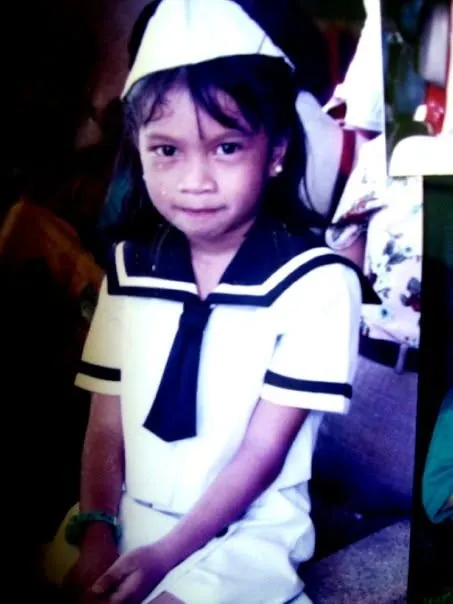 Merce as a little girl in a sailor uniform